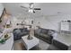 Open living room with tile flooring flows into the kitchen, dining area, and staircase at 11287 Cay Spruce Way, San Antonio, FL 33576