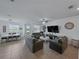 Bright living room features tile flooring, a large TV, and an open dining area at 11287 Cay Spruce Way, San Antonio, FL 33576