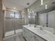 Modern main bathroom featuring a double vanity, sleek fixtures, and glass enclosed shower at 11287 Cay Spruce Way, San Antonio, FL 33576