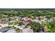 Aerial view of a neighborhood showcases the property's location amongst mature trees and well-maintained homes at 11320 Partridge Dr, Tampa, FL 33625