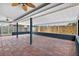 An expansive outdoor patio area with tiled flooring, a screened enclosure, and ample space for gatherings at 11320 Partridge Dr, Tampa, FL 33625