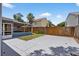 An open backyard area showing both a concrete patio and a screened back porch of the house at 11320 Partridge Dr, Tampa, FL 33625