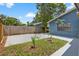 Cozy backyard featuring a concrete patio and small green area with young trees, perfect for relaxing outdoors at 11320 Partridge Dr, Tampa, FL 33625