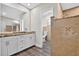 Bathroom showcasing a double sink vanity with granite countertops, tiled shower, and access to the toilet at 11320 Partridge Dr, Tampa, FL 33625