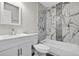 Stylish bathroom with white vanity, toilet, and shower-tub combo with decorative tile at 11320 Partridge Dr, Tampa, FL 33625