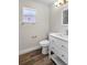 This bathroom features wood flooring, a modern vanity, and a window at 11320 Partridge Dr, Tampa, FL 33625