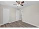 This bedroom features wood flooring, a ceiling fan, and white trim throughout at 11320 Partridge Dr, Tampa, FL 33625
