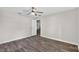 This bedroom features wood flooring, a ceiling fan, and white trim throughout at 11320 Partridge Dr, Tampa, FL 33625