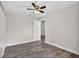 This bedroom features wood flooring, a ceiling fan, and white trim throughout at 11320 Partridge Dr, Tampa, FL 33625