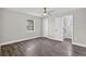 This bedroom features wood flooring, a ceiling fan, closet, window and bathroom access at 11320 Partridge Dr, Tampa, FL 33625