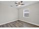 This bedroom features wood flooring, a ceiling fan, and a window at 11320 Partridge Dr, Tampa, FL 33625