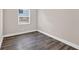 Cozy bedroom featuring wood floors and natural light from the window at 11320 Partridge Dr, Tampa, FL 33625