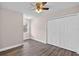 This bedroom features wood flooring, a ceiling fan, closet and a window at 11320 Partridge Dr, Tampa, FL 33625
