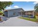Rear exterior showcasing the home's design, yard, and access to a screened-in porch at 11320 Partridge Dr, Tampa, FL 33625