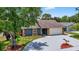 Charming exterior view showcasing a well-maintained home with a paved driveway and an attached garage at 11320 Partridge Dr, Tampa, FL 33625