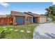 Charming home featuring stone accents, a well-maintained lawn, and stepping stones leading to the entrance at 11320 Partridge Dr, Tampa, FL 33625