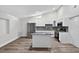 Open kitchen features white cabinets, stainless appliances, and center island at 11320 Partridge Dr, Tampa, FL 33625