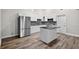 Bright kitchen with white cabinets, stainless steel refrigerator, and center island at 11320 Partridge Dr, Tampa, FL 33625