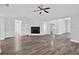 Spacious living room with modern flooring, fireplace, and ceiling fan at 11320 Partridge Dr, Tampa, FL 33625