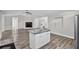 Spacious open-concept living area with wood flooring, a fireplace, and a kitchen island at 11320 Partridge Dr, Tampa, FL 33625