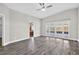 Bright living room featuring wood floors, vaulted ceiling with ceiling fan, and sliding glass doors at 11320 Partridge Dr, Tampa, FL 33625