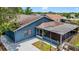 Aerial view of home with screen patio, neutral paint, and manicured yard, surrounded by a wooden fence at 11320 Partridge Dr, Tampa, FL 33625