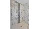 Shower with marble-patterned tiles and a built-in shower head at 11320 Partridge Dr, Tampa, FL 33625