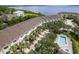 Aerial view of waterfront townhomes featuring community pool and proximity to the water at 115 Brent Cir, Oldsmar, FL 34677