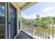 Balcony view of the waterfront, surrounding greenery, and neighborhood at 115 Brent Cir, Oldsmar, FL 34677