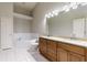 Spacious bathroom featuring a large tub, double sinks, and neutral tile at 115 Brent Cir, Oldsmar, FL 34677