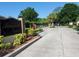 Seaside Estates entrance with brick accents, mature landscaping, and secure gate at 115 Brent Cir, Oldsmar, FL 34677