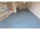 Spacious garage with shelving for storage and an automatic door at 115 Brent Cir, Oldsmar, FL 34677