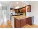 Updated kitchen features granite countertops, stainless steel appliances, and wood cabinetry at 115 Brent Cir, Oldsmar, FL 34677