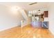 Open living space with hardwood floors, open staircase, and an open flow to the kitchen at 115 Brent Cir, Oldsmar, FL 34677