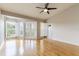 Bright living room with hardwood floors, ceiling fan, and lots of natural light at 115 Brent Cir, Oldsmar, FL 34677