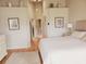 Bright primary bedroom with hardwood floors and decorative artwork at 115 Brent Cir, Oldsmar, FL 34677