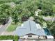 The home features a new roof, skylights, private pool, and outdoor living space surrounded by mature trees at 11525 Country Oaks Dr, Tampa, FL 33618