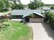 Aerial view of home featuring a well manicured lawn and mature landscaping at 11525 Country Oaks Dr, Tampa, FL 33618