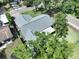 The home features mature trees, a well manicured lawn, private pool, outdoor living space, and trampoline at 11525 Country Oaks Dr, Tampa, FL 33618