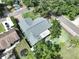 The home features mature trees, a well manicured lawn, private pool, outdoor living space and trampoline at 11525 Country Oaks Dr, Tampa, FL 33618