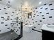 This stunning, fully remodeled bathroom features a glass shower, sleek tub, chandelier, and modern finishes at 11525 Country Oaks Dr, Tampa, FL 33618