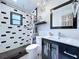 Well-lit bathroom with modern fixtures, chandelier, black and white tile, and shower at 11525 Country Oaks Dr, Tampa, FL 33618