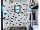 Close-up of updated bathroom with decorative tile, shower, and modern hardware at 11525 Country Oaks Dr, Tampa, FL 33618