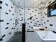 This sleek, remodeled bathroom features a glass shower, modern tub, a chandelier, and contemporary design at 11525 Country Oaks Dr, Tampa, FL 33618