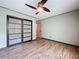 The bedroom has sliding closet doors, a lighted ceiling fan and an entrance into another room at 11525 Country Oaks Dr, Tampa, FL 33618