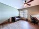 Bedroom featuring a sofa, desk, neutral paint color and wood-look floors is perfect for an office space at 11525 Country Oaks Dr, Tampa, FL 33618