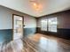 View of dining room featuring wood floors, beadboard accent, and a window overlooking an outdoor bar and pool at 11525 Country Oaks Dr, Tampa, FL 33618