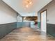 View of dining room and living room featuring wood floors and stylish wood accent wall at 11525 Country Oaks Dr, Tampa, FL 33618