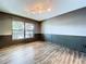 Dining room featuring wood-style floors, wainscoting, modern lighting, and a view of the back yard at 11525 Country Oaks Dr, Tampa, FL 33618