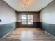 Dining room with wood floors, wainscoting, and modern light fixture at 11525 Country Oaks Dr, Tampa, FL 33618